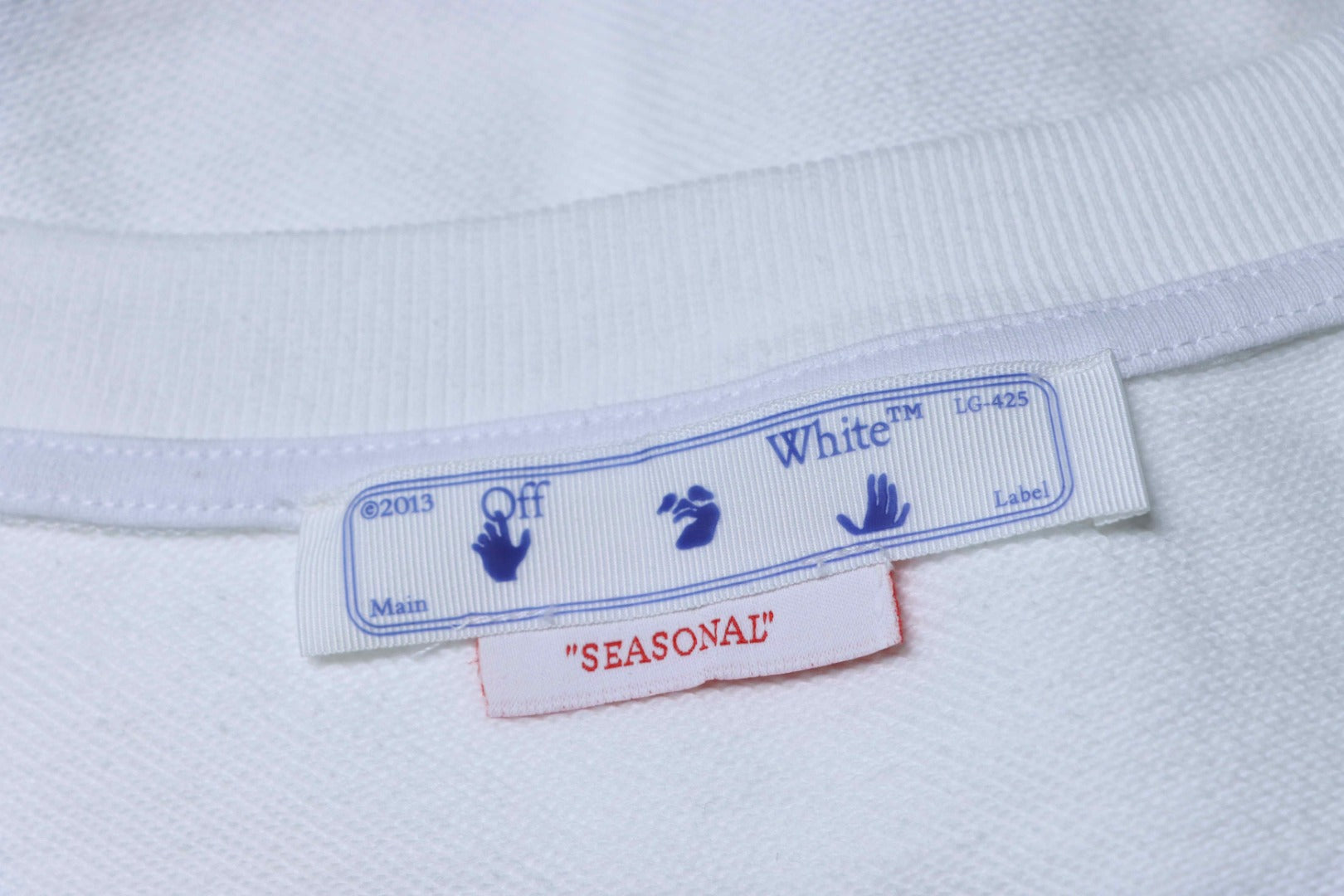 Off-white sweatshirt inside neck label with care and brand text