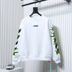 Off-white sweatshirt with green cannabis leaf graphic on sleeves