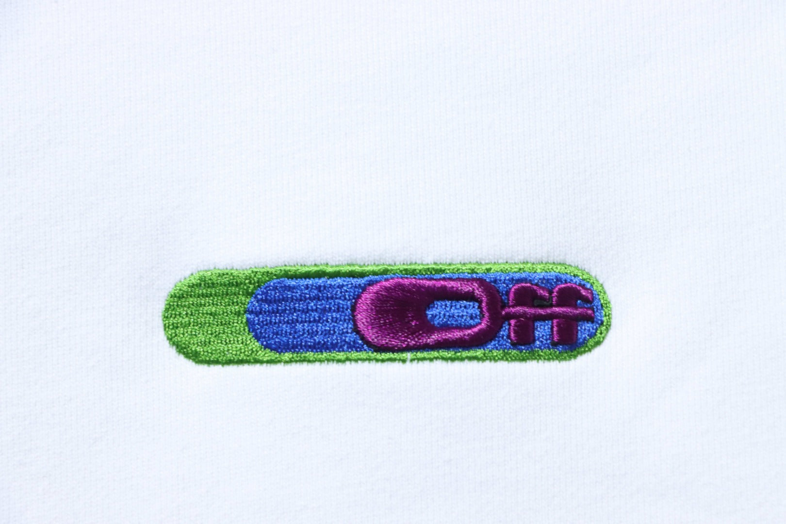 Off-white sweatshirt chest graphic in green, blue, and purple