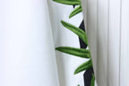 Off-white sweatshirt sleeve with embroidered green cannabis-leaf design