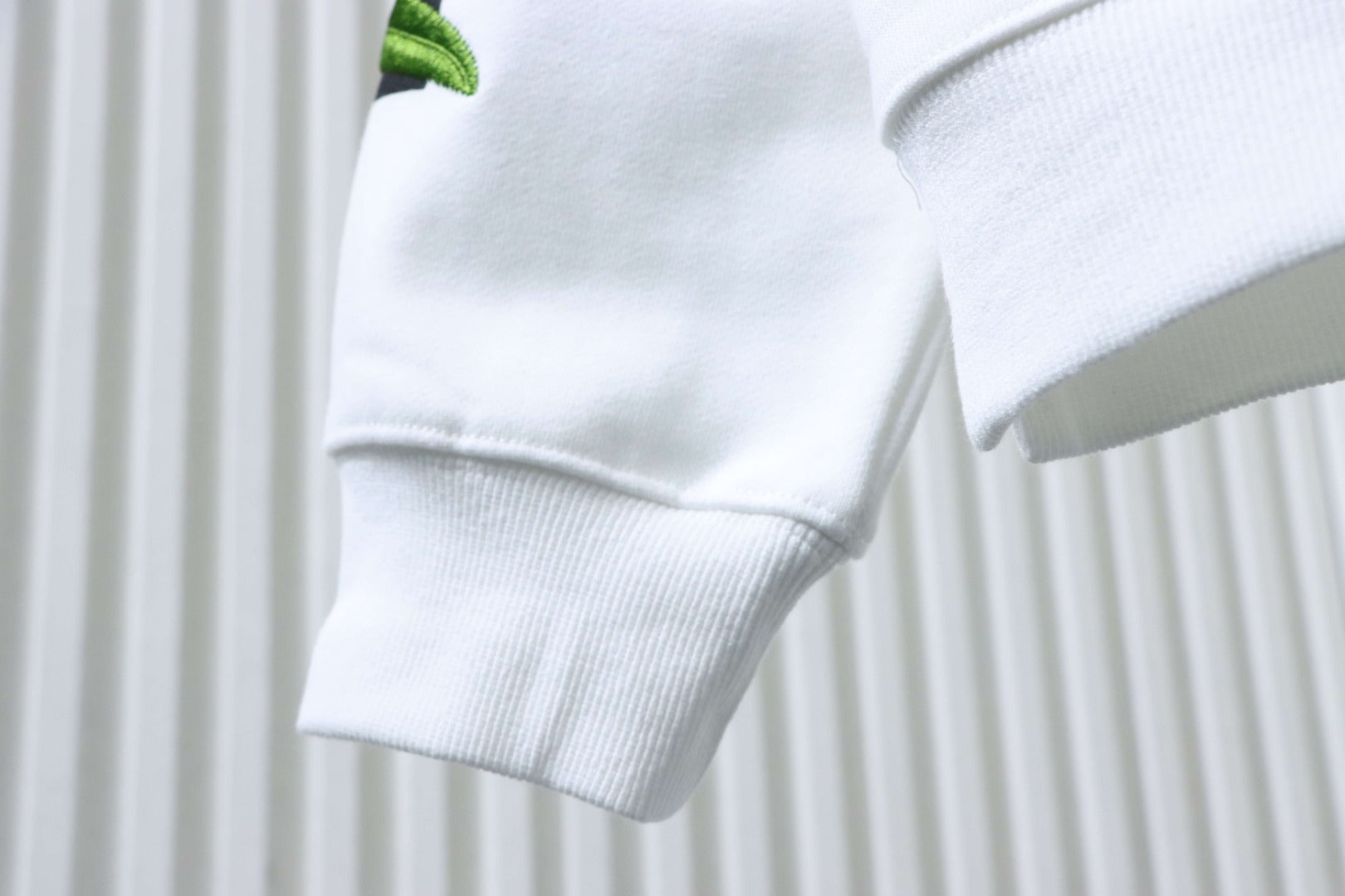 Off-white sweatshirt sleeve cuff and side seam close-up