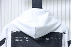 Off White hoodie close-up: draped hood with black distressed graphic band