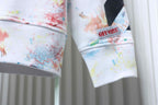 Off White hoodie sleeve hem with 'OFF' text patch and colorful paint splatter