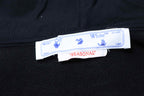 Black hoodie with neck label and Seasonal size tag