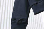 Black hoodie sleeve section with ribbed cuff and curved hem