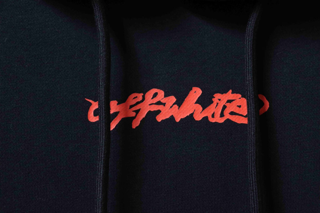 Off White hoodie close-up of red logo text on dark fabric