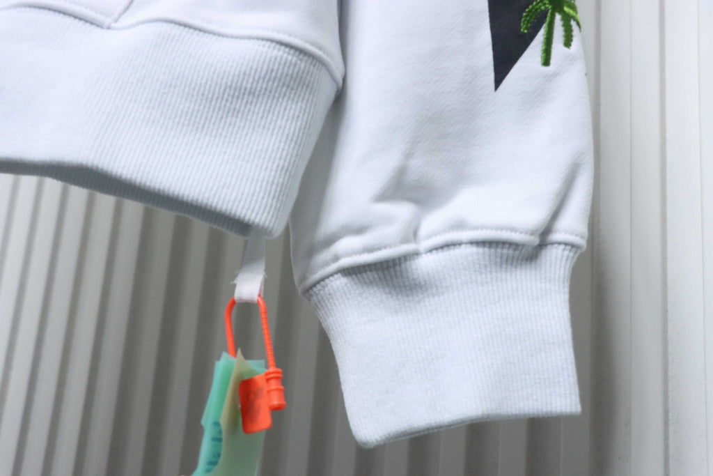 Off-White off-white hoodie cuff detail with leaf print and hanging drawstring ends.