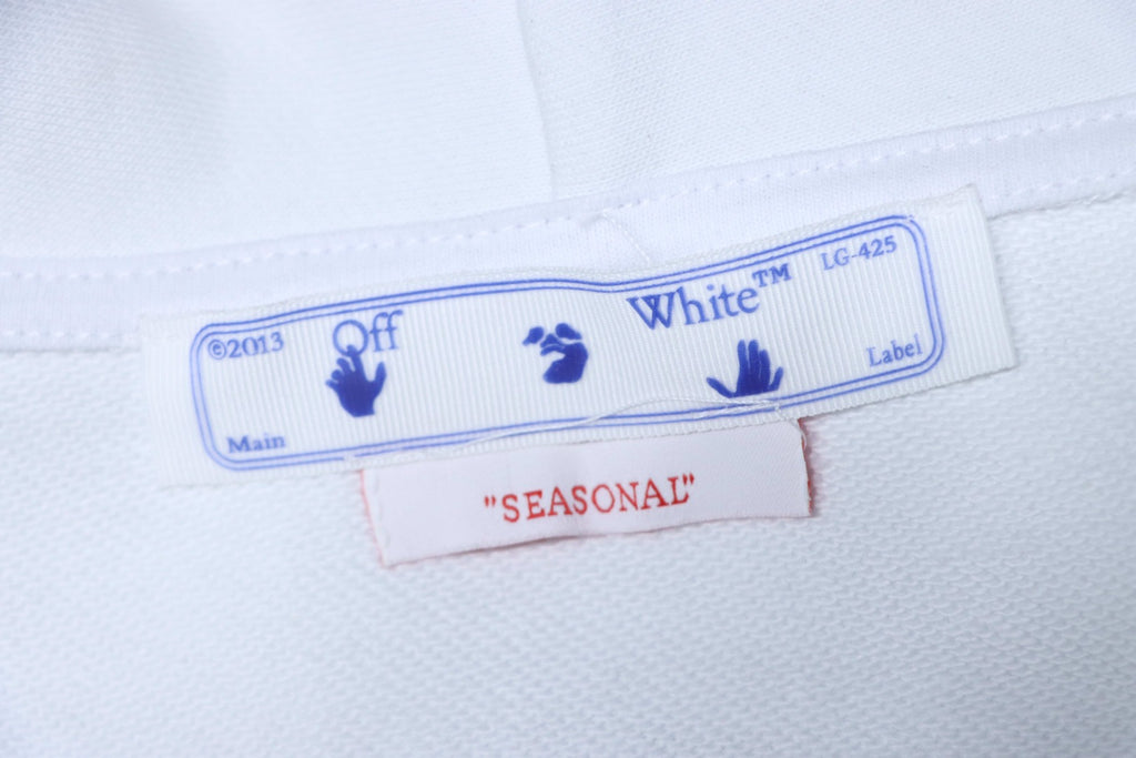 Off-White off-white hoodie care label with Off-White branding and "Seasonal" text.