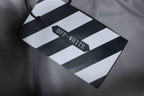 OFF-WHITE branded tag attached to a grey jacket