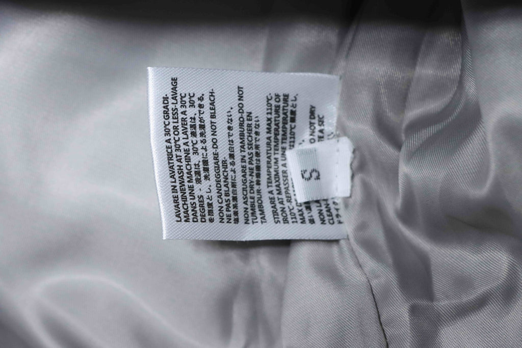 Off White size S care label on inside of grey jacket