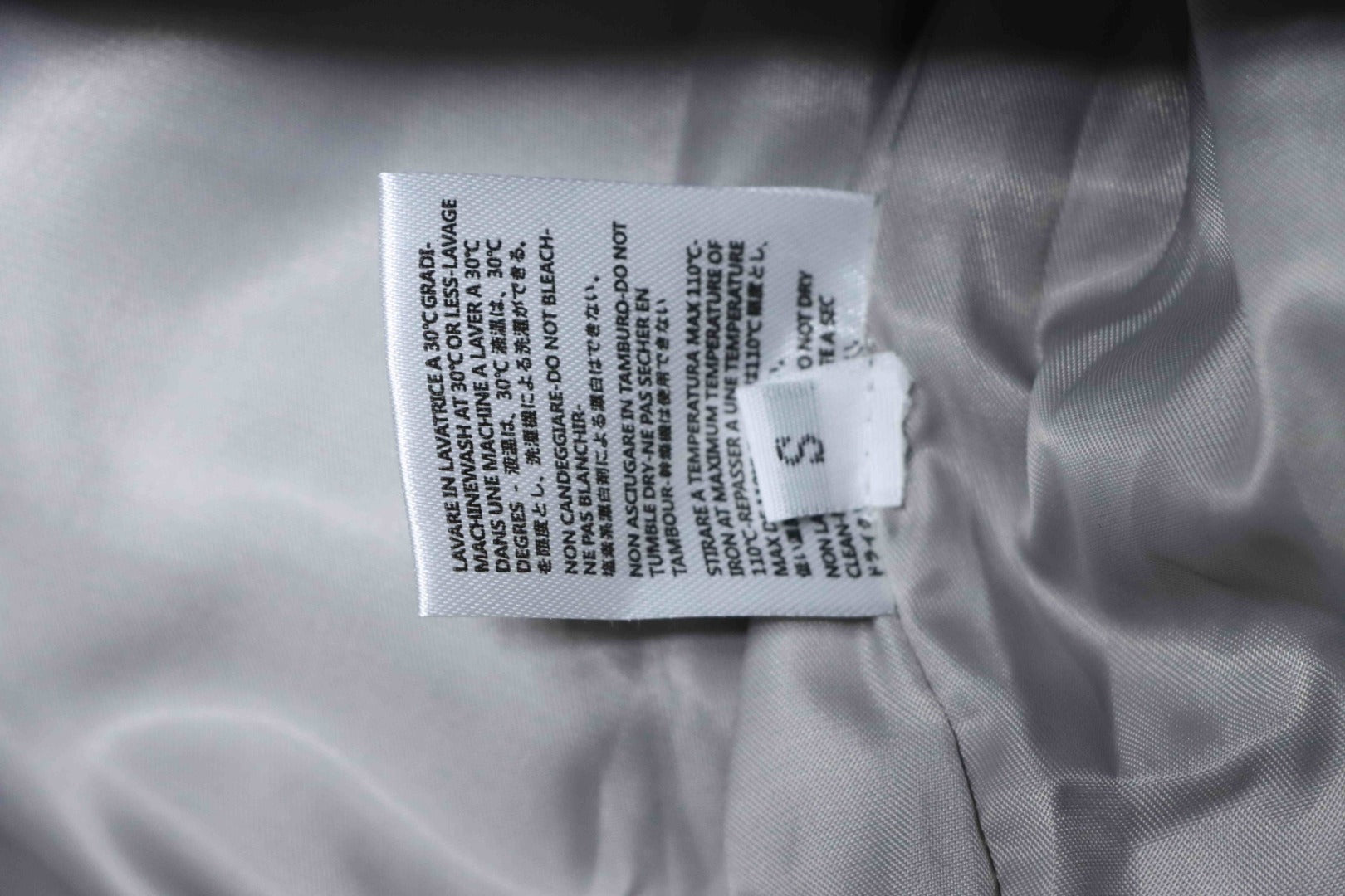 Off White size S care label on inside of grey jacket