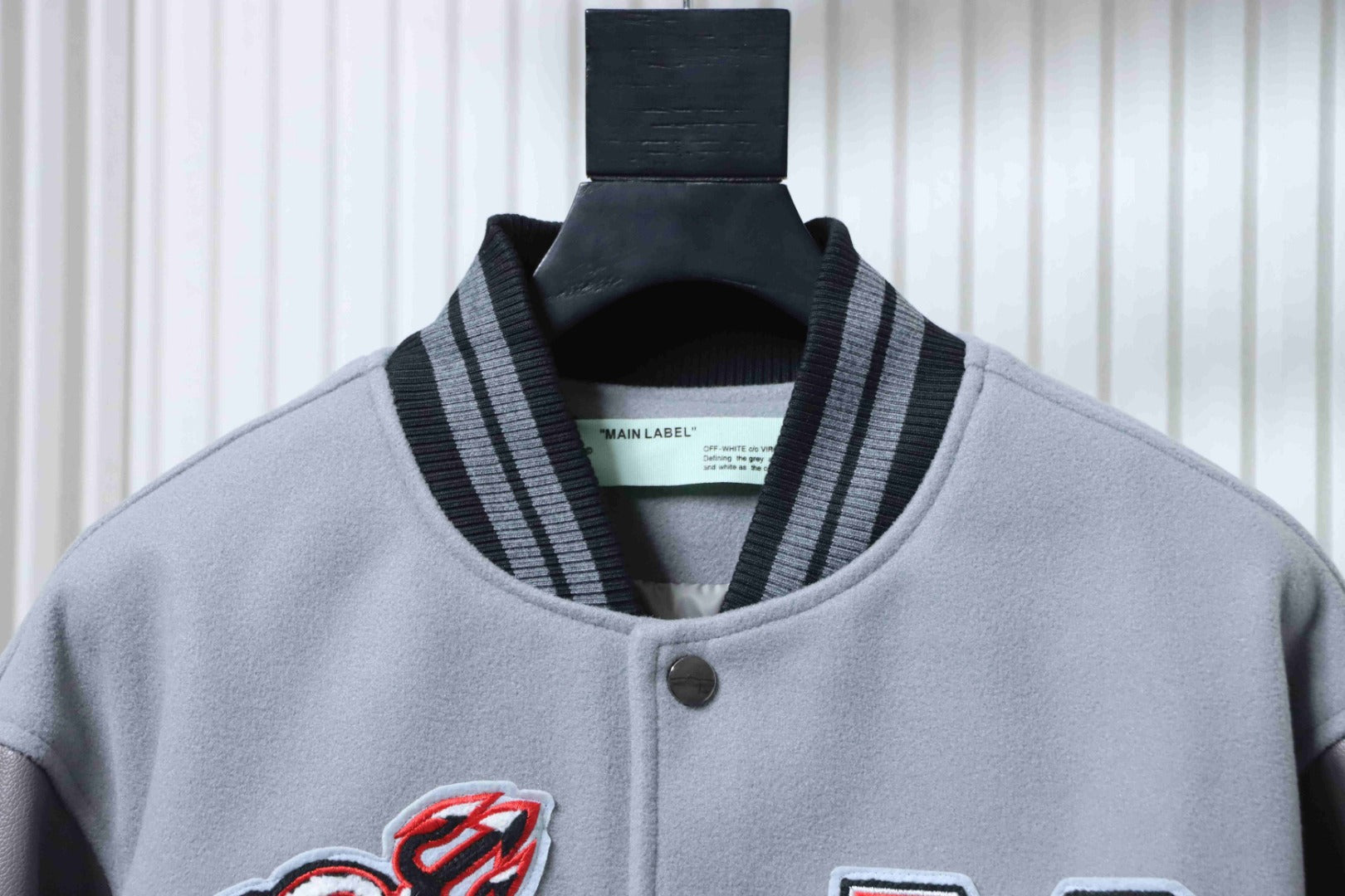 Off White grey jacket collar with black ribbed trim and snap button