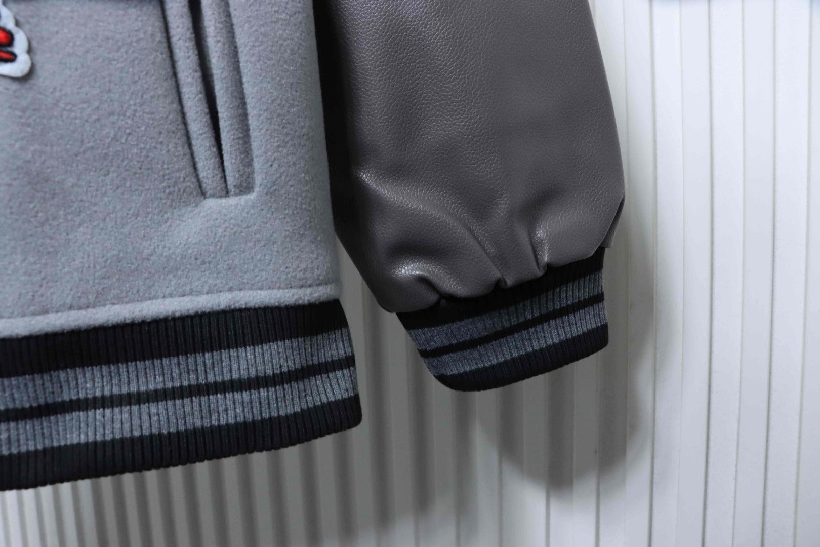 Off White grey jacket with black faux leather sleeve cuff and striped rib hem