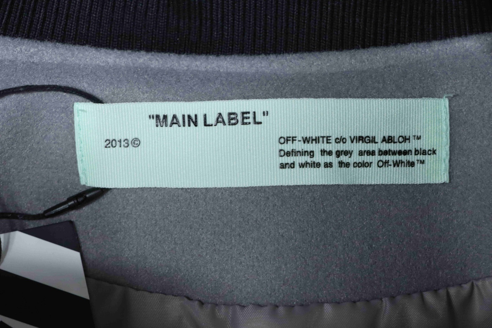 Off White clothing neckline label on dark fabric