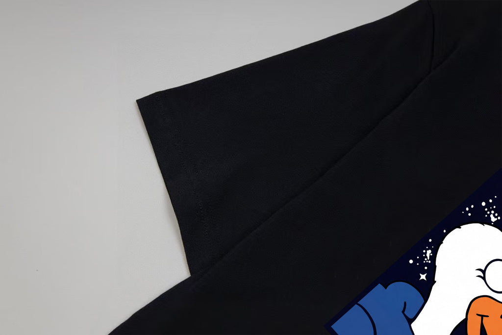 Black short-sleeve T-shirt sleeve with part of colorful graphic print