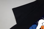Black short-sleeve T-shirt sleeve with part of colorful graphic print