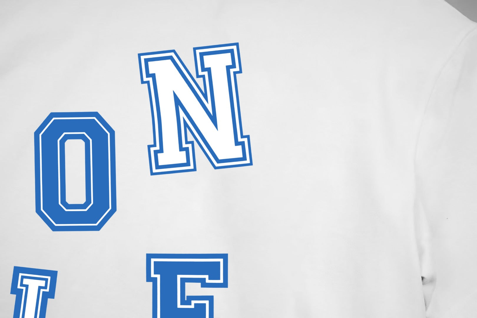 White T-shirt close-up of blue letter graphic