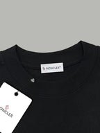 Black crewneck T-shirt neckline close-up with Moncler logo tag