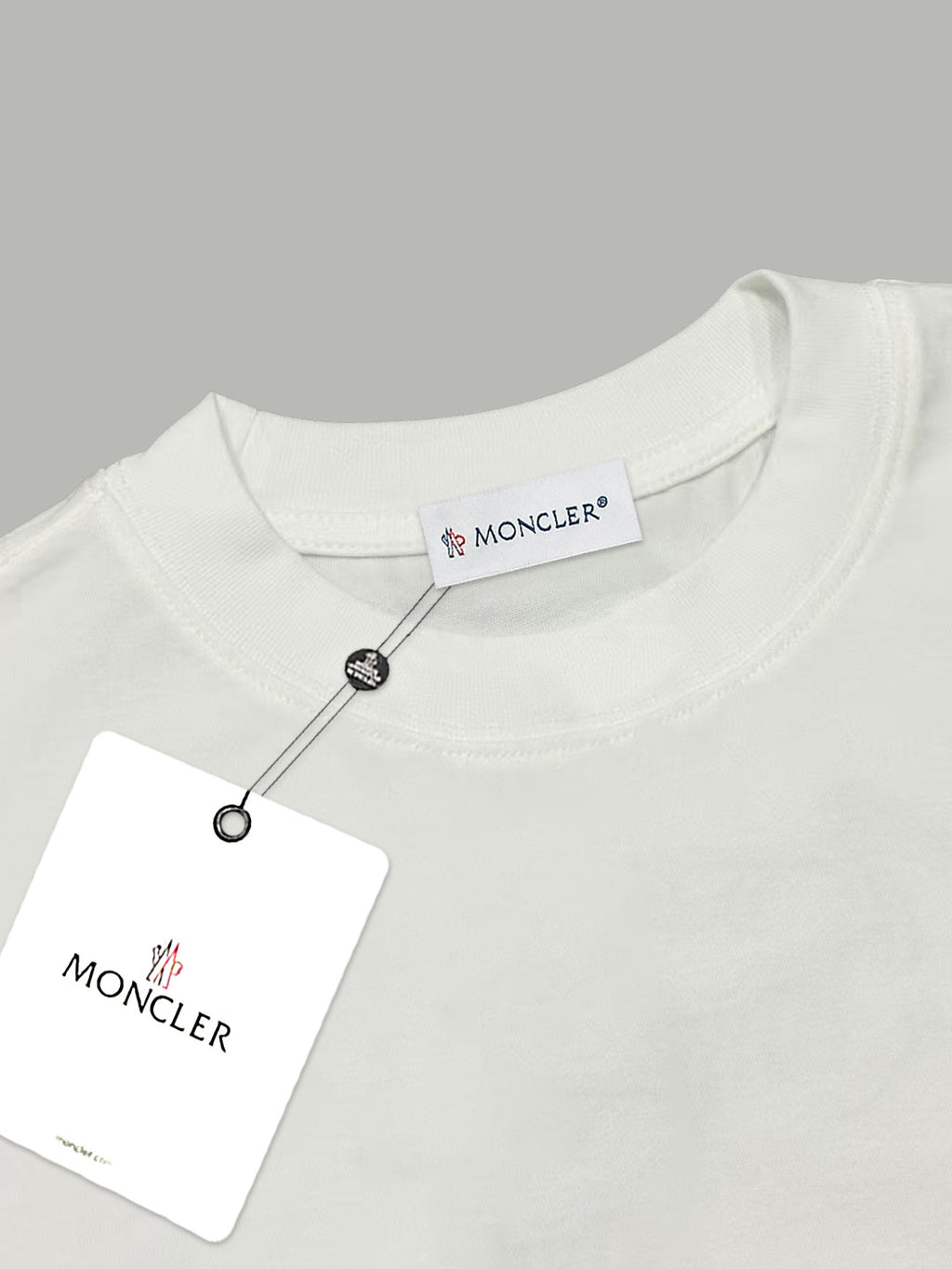 Moncler white T-shirt neckline with brand label and snap-button detail