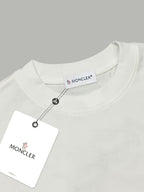 White crewneck T-shirt neckline with hanging Moncler tag