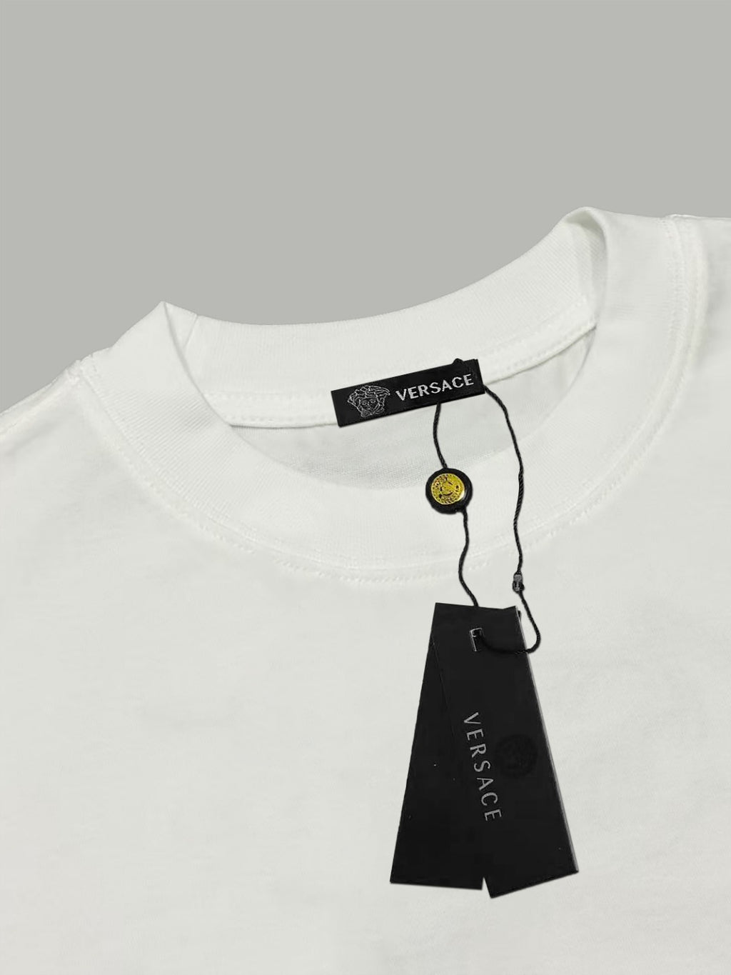 White Versace T-shirt collar with brand label and hanging tag
