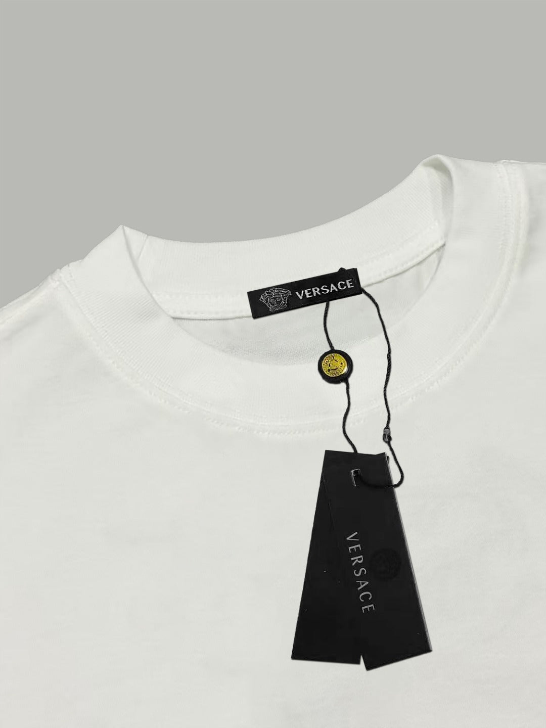 White Versace T-shirt with black neck label and hanging tag