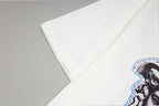 White Versace T-shirt sleeve and shoulder seam with partial Medusa print