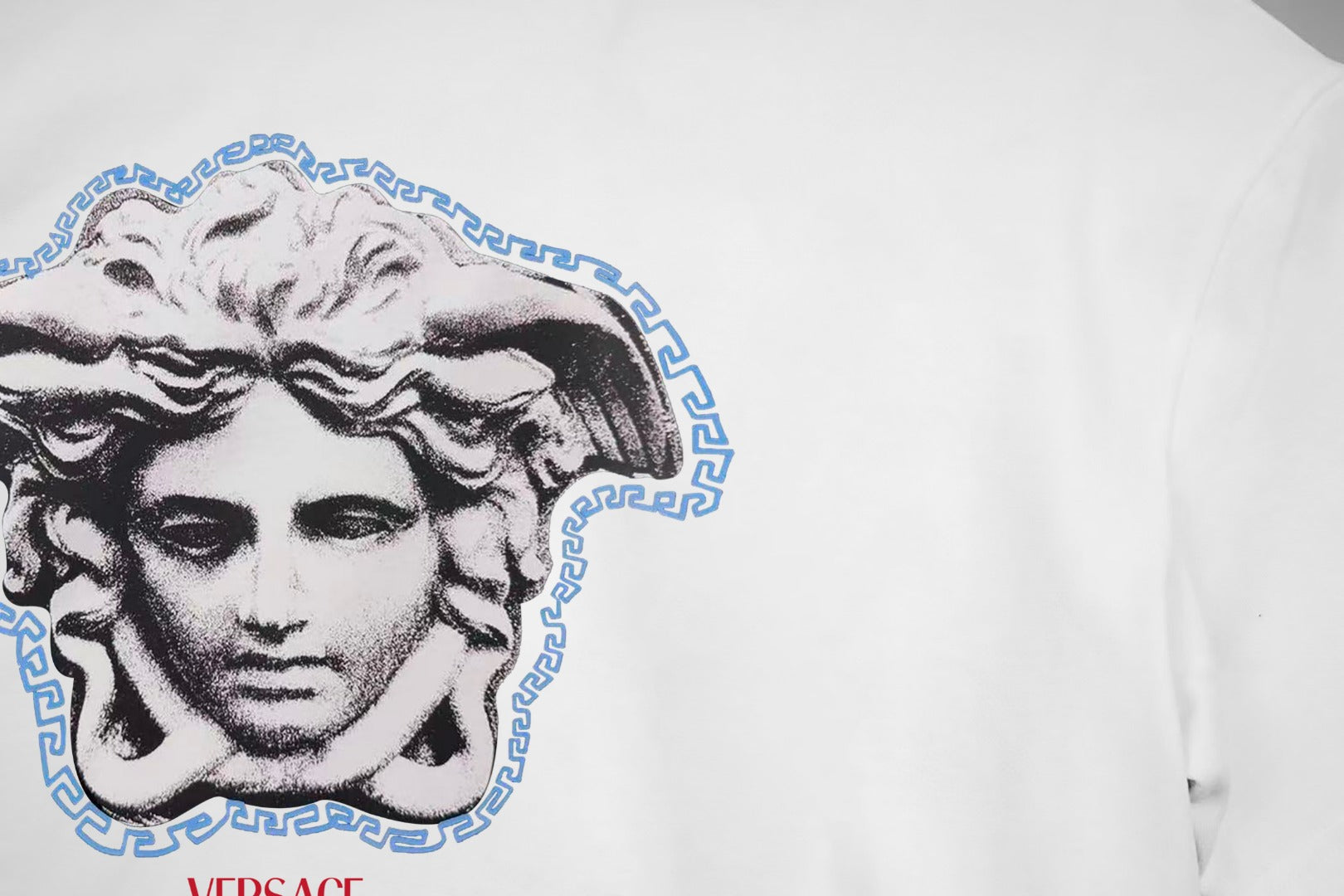 White Versace T-shirt close-up of blue Medusa head graphic