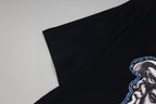 Black T-shirt sleeve with partial blue Medusa graphic