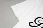White T-shirt sleeve and hem close-up with partial black logo print