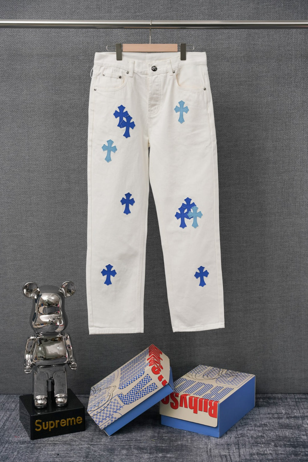 White denim pants with blue cross print, button fly and front pockets