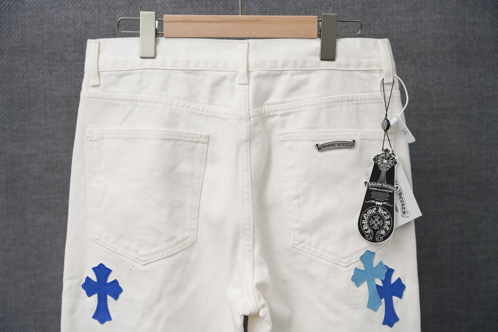White pants with blue cross prints, zip fly and front pockets