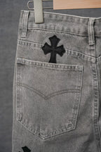 Chrome pants back pocket area, light gray denim with black cross patch
