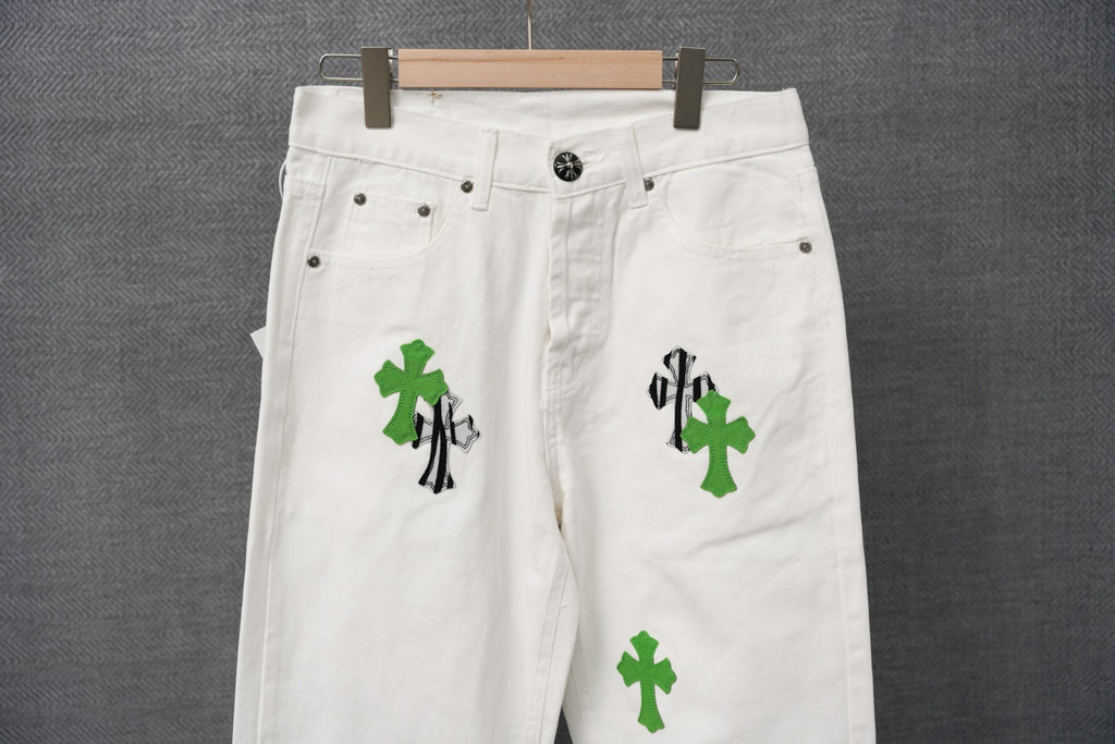 White denim pants with green cross and black striped graphic patch detail
