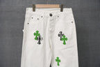 White denim pants with green cross and black striped graphic patch detail
