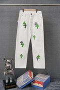 White denim pants with green cross-like graphic patches and black outlines, straight leg