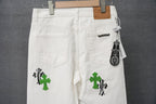 White pants with green cross graphic, front pockets, and hanging size tag