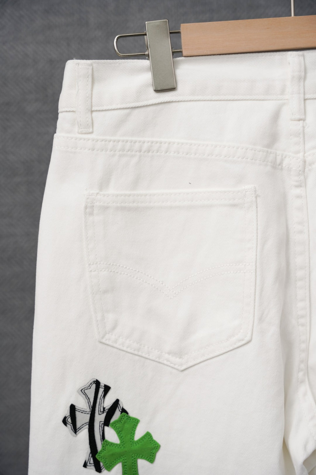 White pants with large back pocket and subtle stitched details