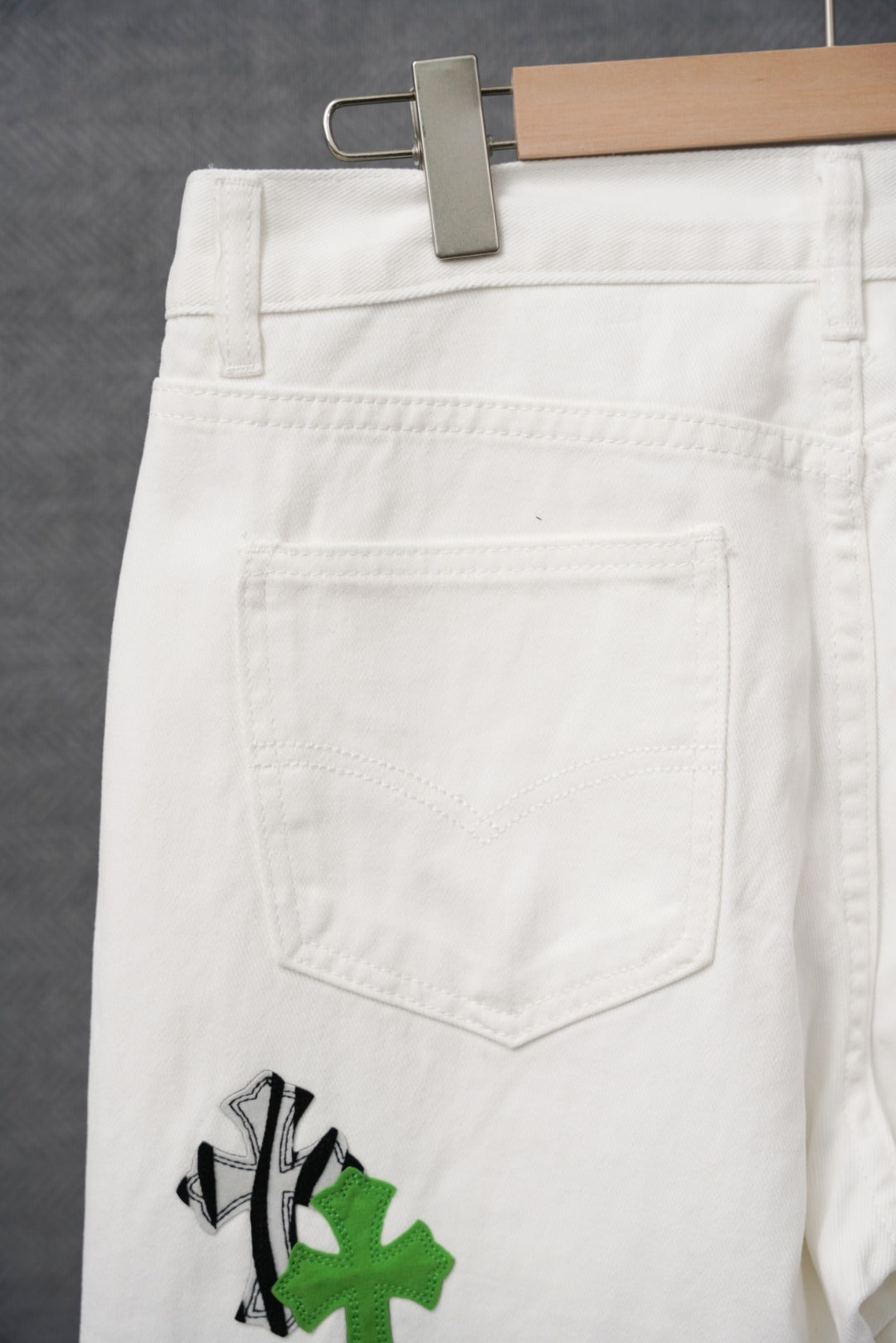 White pants with large back pocket and subtle stitched details