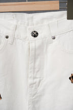 White denim pants with button waistband and leopard cross applique