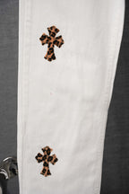 White pants with leopard-print cross patch on upper and lower leg