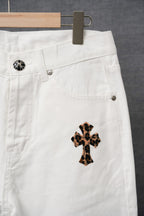 White pants close-up with side pocket and leopard-print cross patch detail