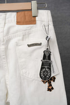 White pants with leopard-print cross appliques, patch pocket detail, and hanging tag