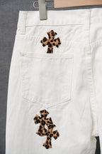 White pants with leopard-print cross appliques and two front patch pockets