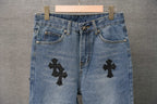 Blue denim Chrome pants waistband with button closure and black cross patches.