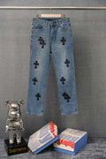 Light blue denim pants with black cross patchwork detailing on legs