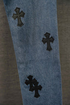 Blue denim Chrome pants leg with three black cross patches, spaced apart.