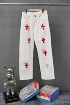 White pants with red cross appliques, button-front and five-pocket style