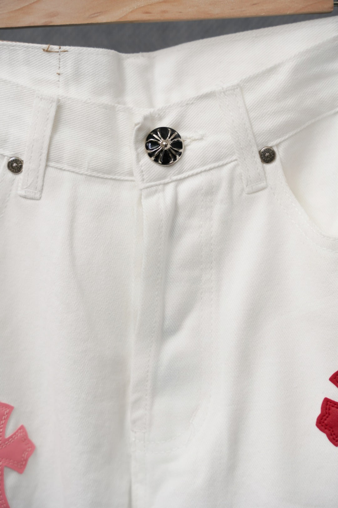 White pants with black button and red cross applique on the leg