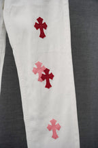 White pants with three red cross appliques along the leg